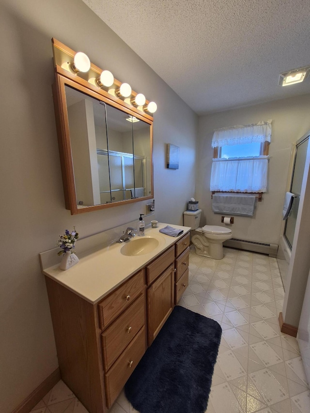 bathroom featuring a baseboard heating unit, toilet, an enclosed shower, a textured ceiling, and vanity