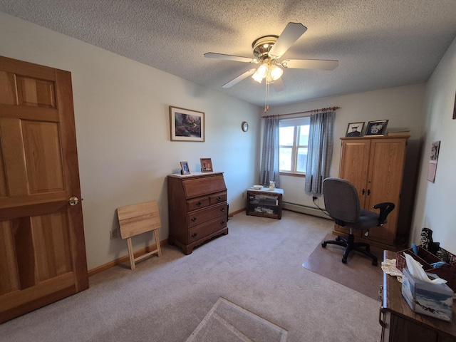 home office with baseboard heating, a ceiling fan, a textured ceiling, baseboards, and light colored carpet