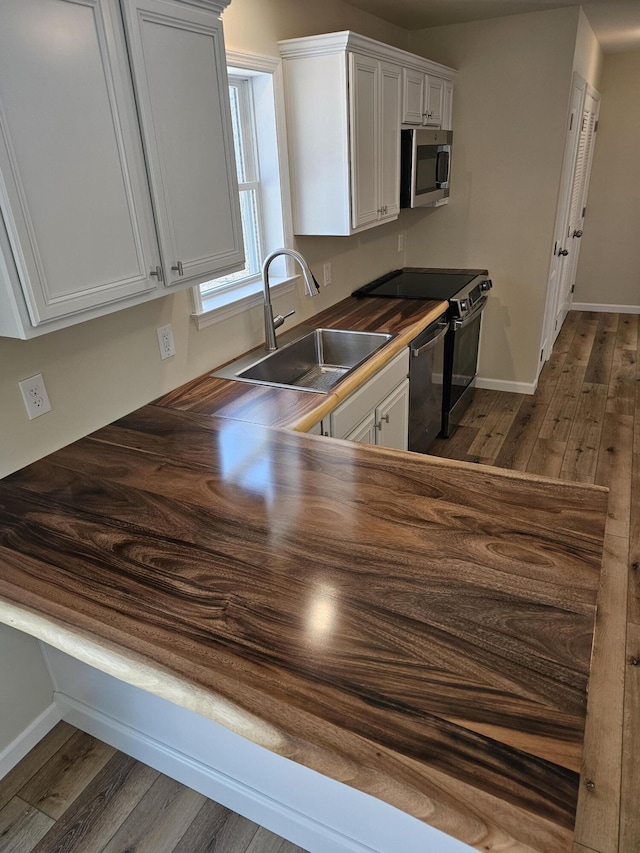 310 Emery Mills Rd, Shapleigh, ME 04076 - kitchen featuring appliances with stainless steel finishes, dark wood-style floors, white cabinets, and wood counters