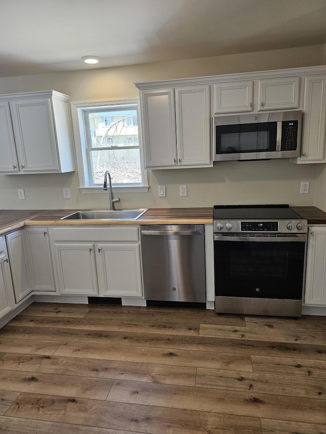 310 Emery Mills Rd, Shapleigh, ME 04076 - kitchen featuring stainless steel appliances, dark wood-style flooring, white cabinetry, and recessed lighting