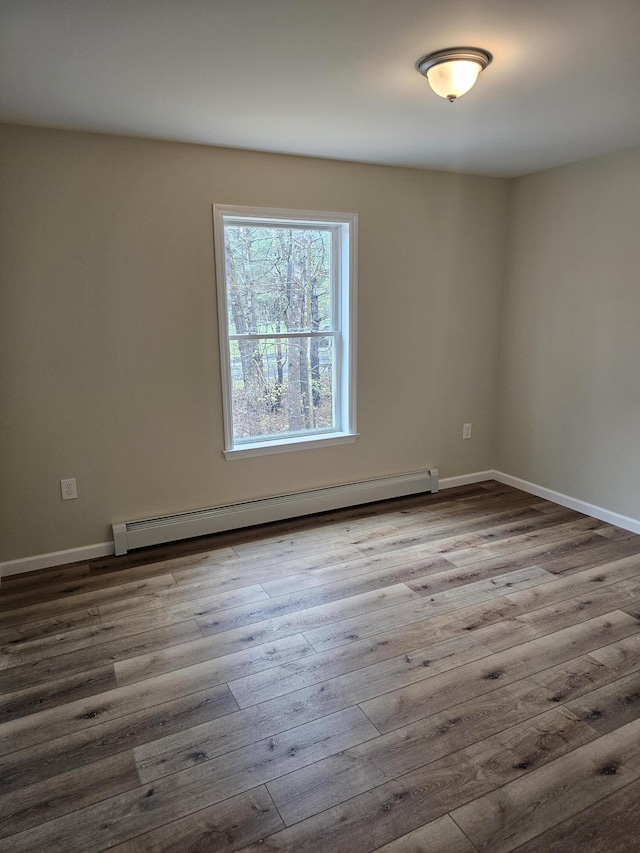 310 Emery Mills Rd, Shapleigh, ME 04076 - empty room featuring a baseboard radiator and wood finished floors