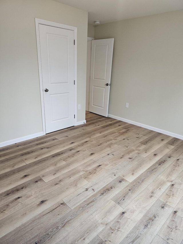 310 Emery Mills Rd, Shapleigh, ME 04076 - unfurnished bedroom featuring wood finished floors and baseboards