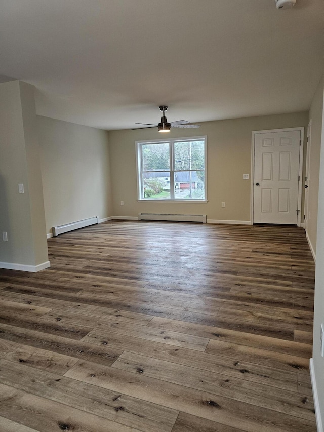 310 Emery Mills Rd, Shapleigh, ME 04076 - unfurnished living room featuring a baseboard heating unit and wood finished floors