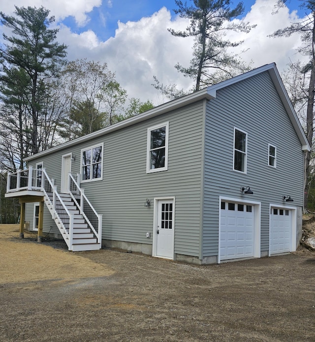 310 Emery Mills Rd, Shapleigh, ME 04076 - back of property with stairway, a deck, and a garage