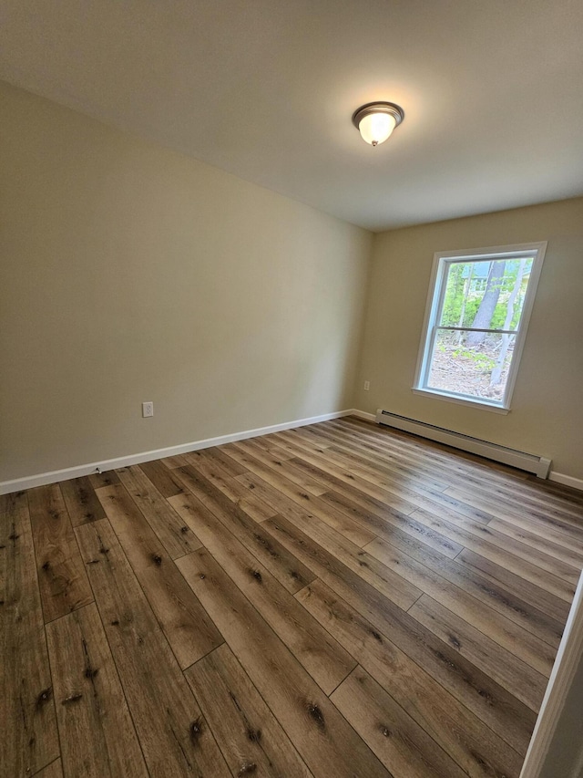 310 Emery Mills Rd, Shapleigh, ME 04076 - unfurnished room featuring baseboard heating and dark wood finished floors