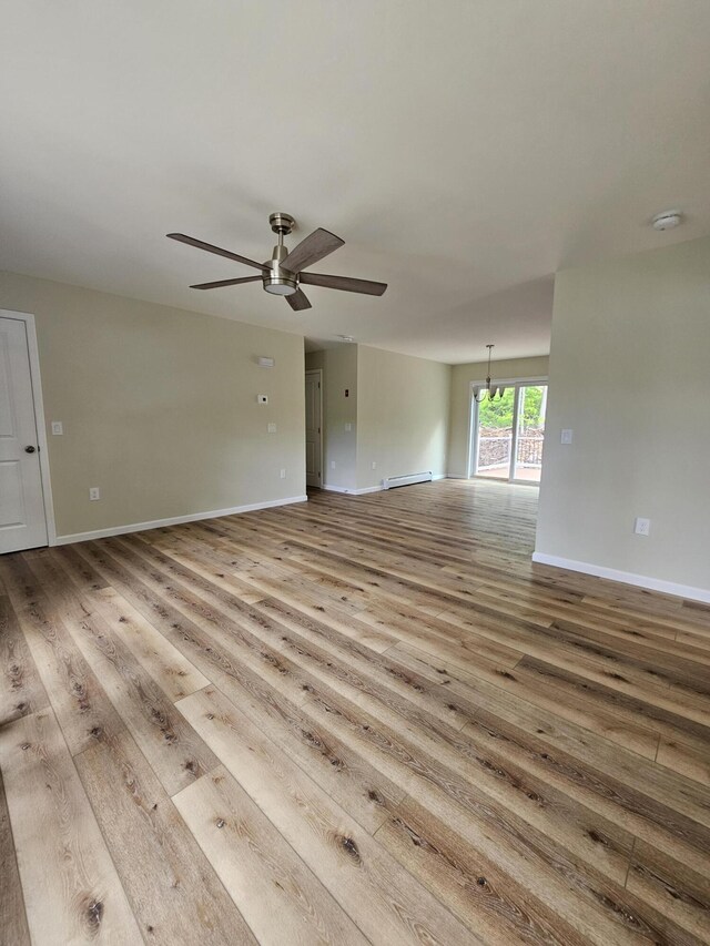 310 Emery Mills Rd, Shapleigh, ME 04076 - empty room with ceiling fan, wood finished floors, a baseboard radiator, and a smoke detector