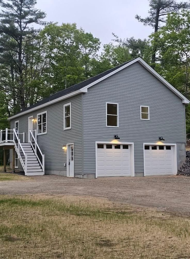 310 Emery Mills Rd, Shapleigh, ME 04076 - back of property with dirt driveway, stairs, a wooden deck, and view of scattered trees