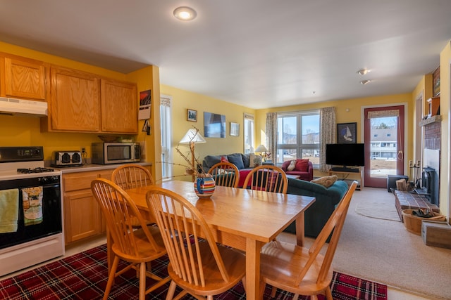 dining room featuring dark colored carpet