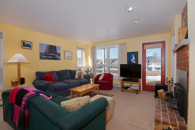 carpeted living room featuring baseboard heating and a wood stove