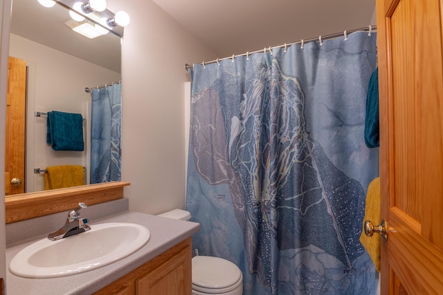 bathroom with a shower with curtain, toilet, and vanity