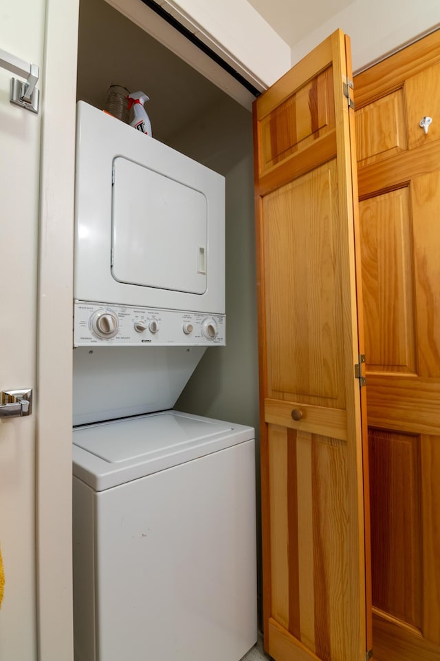 laundry area with laundry area and stacked washer / dryer