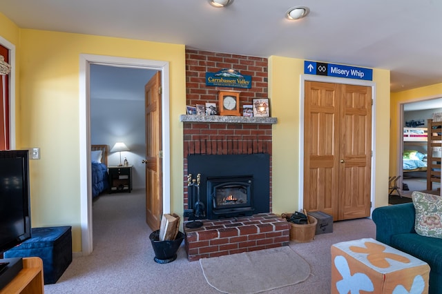 living area featuring carpet flooring and a fireplace