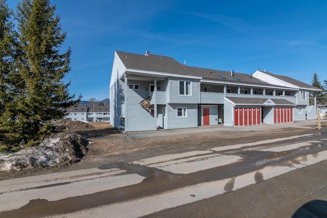 multi unit property featuring a garage and a balcony