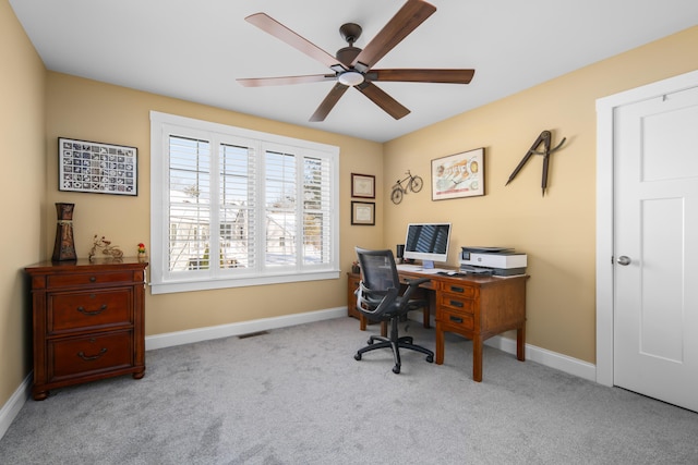 carpeted office with visible vents, baseboards, and ceiling fan