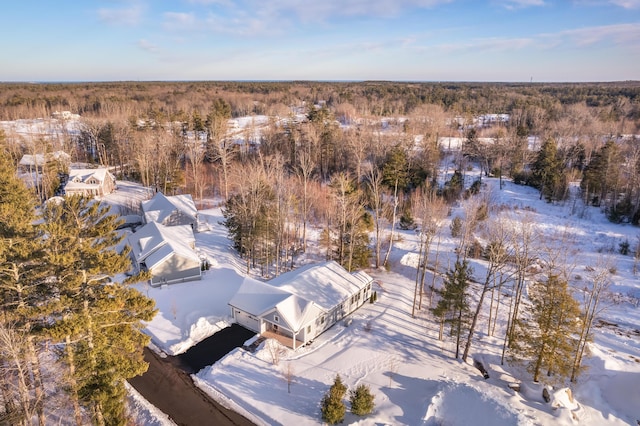 snowy aerial view with a forest view