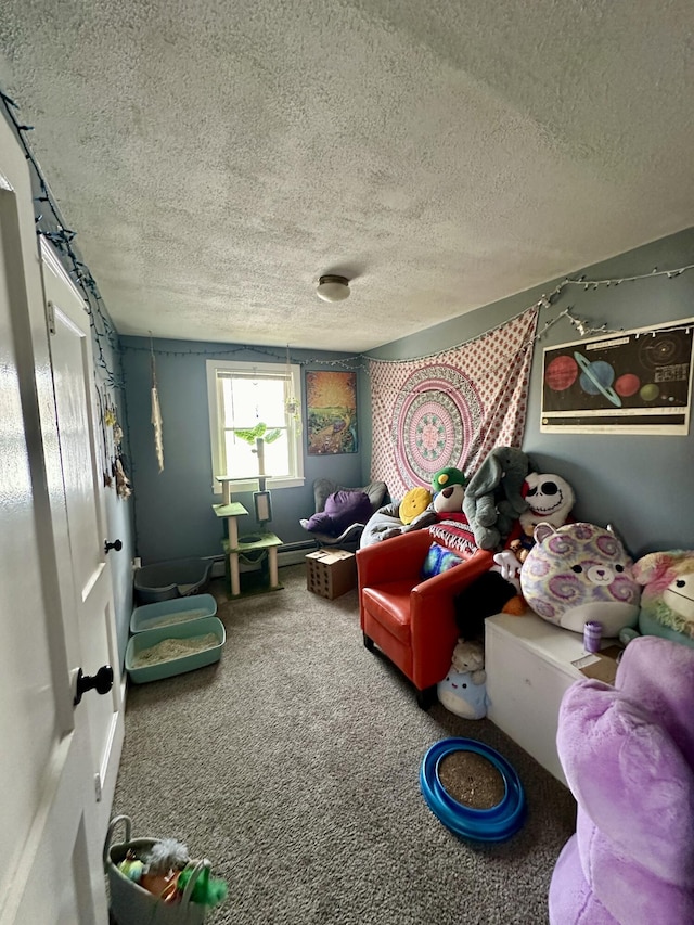 game room featuring carpet floors and a textured ceiling
