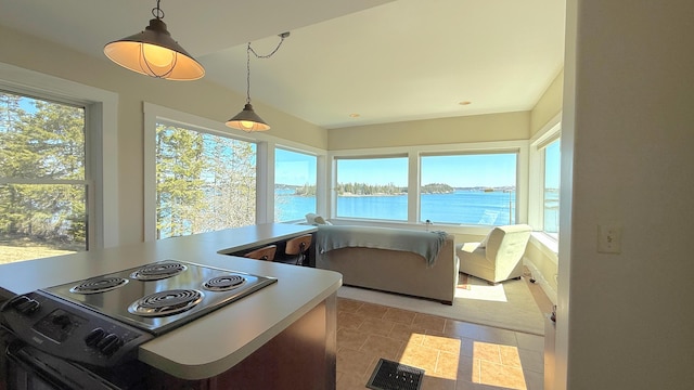 sunroom / solarium with visible vents and a water view