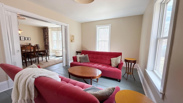 living room with plenty of natural light, baseboards, and wood finished floors