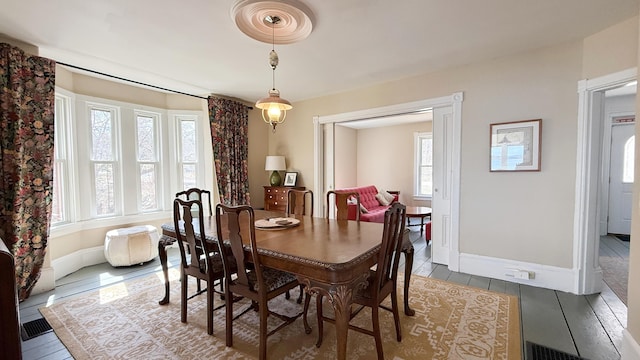 dining space with plenty of natural light and baseboards