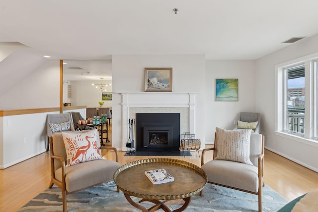 105 Chandlers Wharf Unit 105, Portland, ME 04101 - sitting room featuring wood finished floors, a tiled fireplace, and baseboards