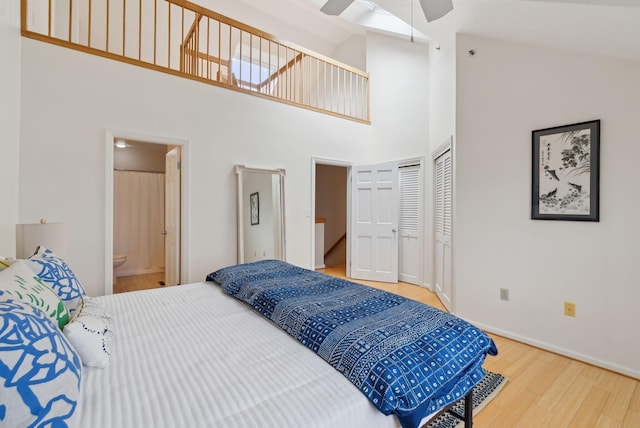 105 Chandlers Wharf Unit 105, Portland, ME 04101 - bedroom with wood finished floors, high vaulted ceiling, ensuite bath, baseboards, and a ceiling fan