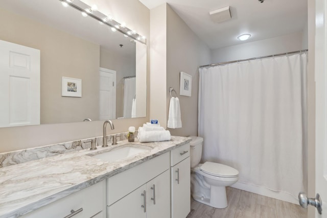 105 Chandlers Wharf Unit 105, Portland, ME 04101 - full bath featuring vanity, toilet, and wood finished floors