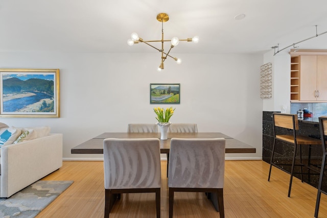 105 Chandlers Wharf Unit 105, Portland, ME 04101 - dining room with a chandelier, wood finished floors, and baseboards
