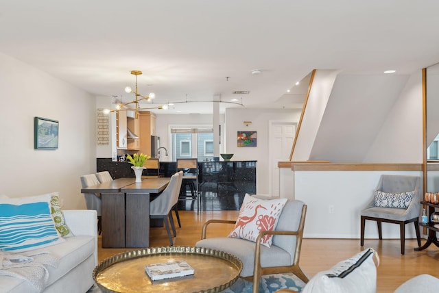105 Chandlers Wharf Unit 105, Portland, ME 04101 - living area featuring light wood-style flooring and a chandelier