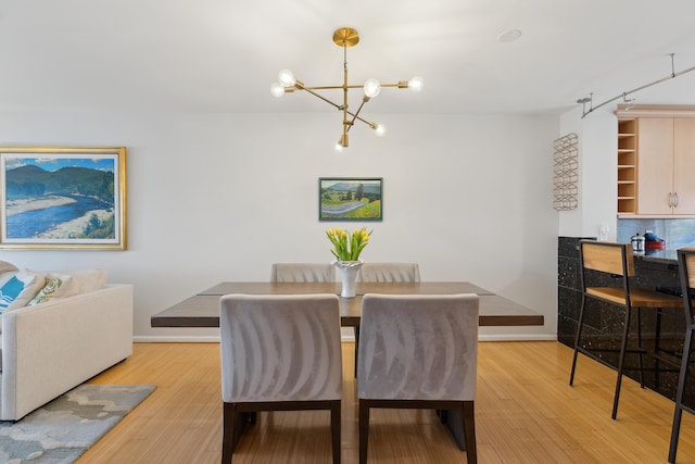 105 Chandlers Wharf Unit 105, Portland, ME 04101 - dining area featuring a chandelier, wood finished floors, and baseboards