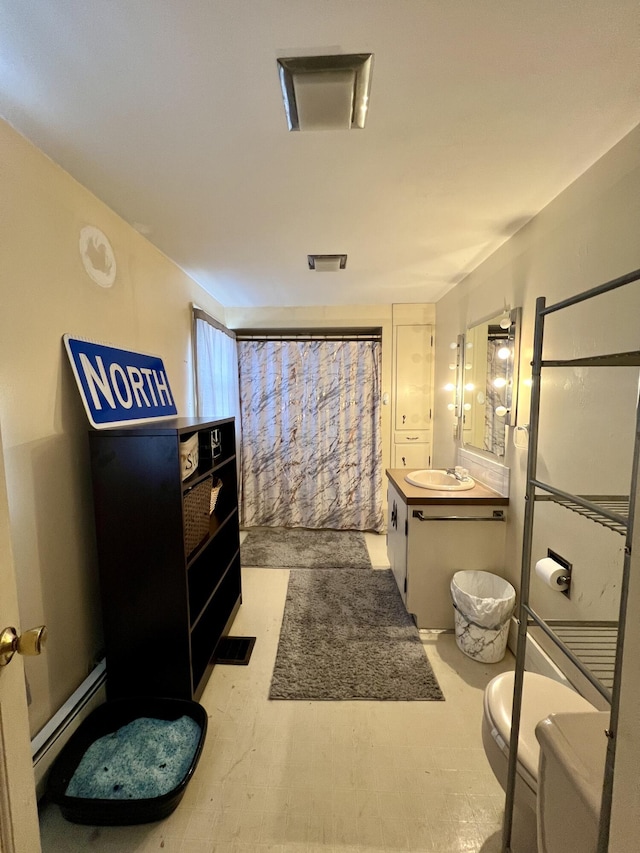 full bath with vanity, a baseboard heating unit, toilet, and a shower with curtain