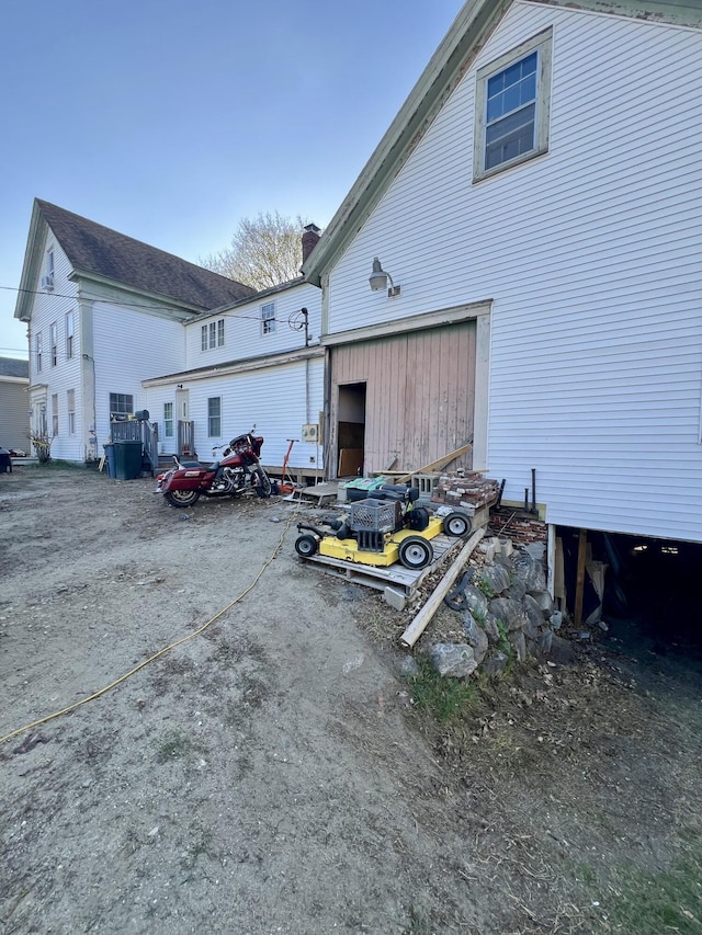 rear view of house featuring a chimney