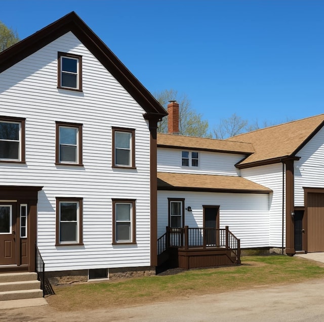 rear view of property with a chimney