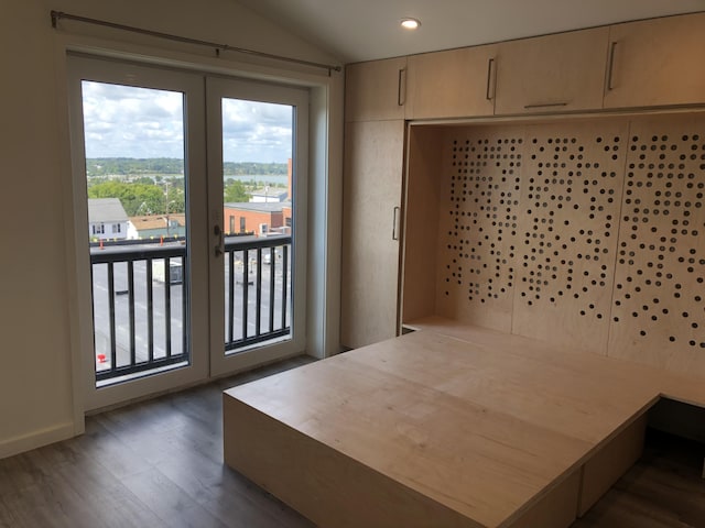 bedroom with dark wood finished floors, lofted ceiling, recessed lighting, and access to exterior