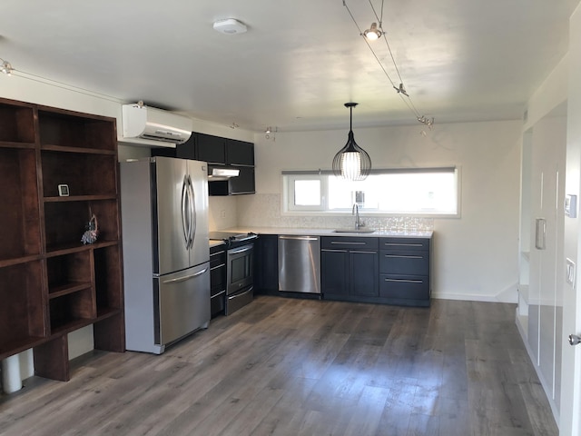 kitchen featuring a wall mounted air conditioner, a sink, dark wood finished floors, stainless steel appliances, and light countertops