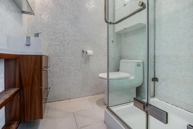 12 Romasco Ln, Portland, ME 04101 - bathroom with tile walls, toilet, tile patterned floors, and vanity