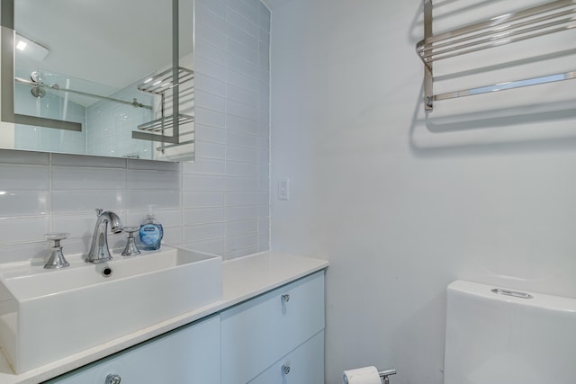 12 Romasco Ln, Portland, ME 04101 - bathroom with decorative backsplash, vanity, toilet, and a shower