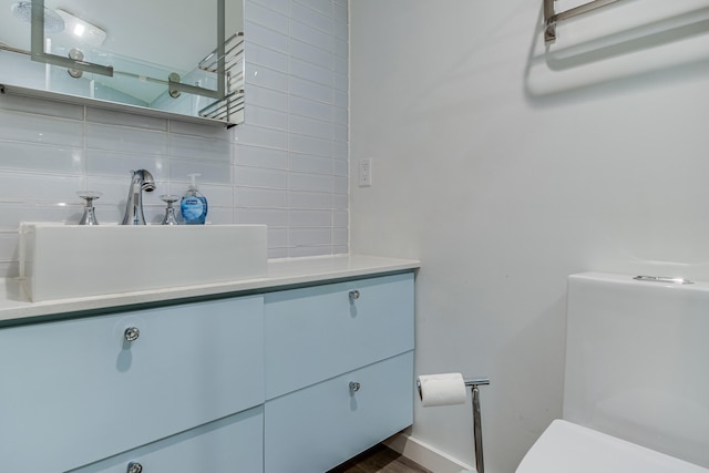 12 Romasco Ln, Portland, ME 04101 - bathroom featuring toilet, tasteful backsplash, and vanity