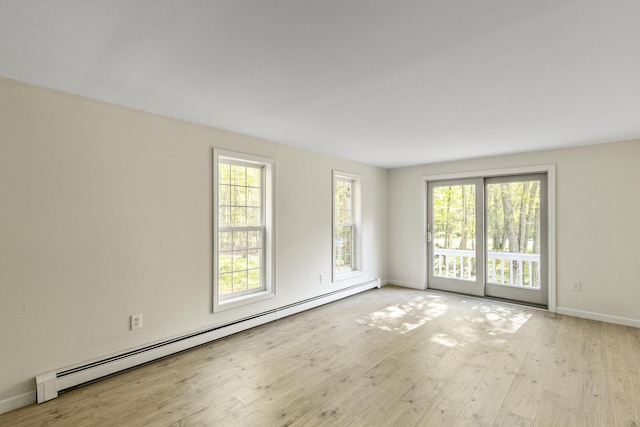 10 Trues Rd, Lincolnville, ME 04849 - empty room with baseboard heating, light wood-style flooring, and baseboards