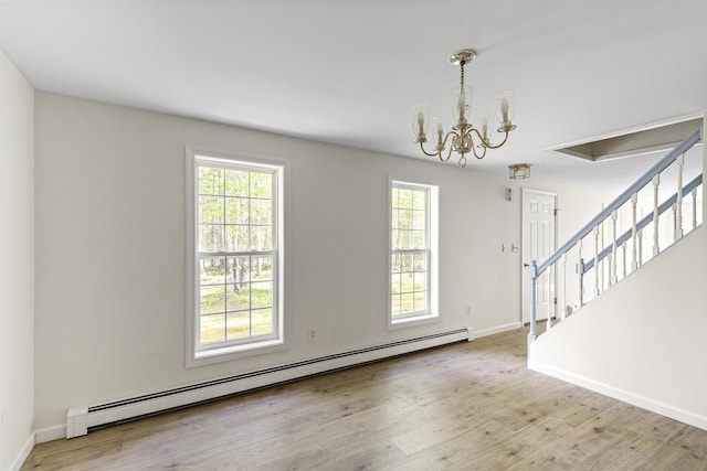 10 Trues Rd, Lincolnville, ME 04849 - empty room with baseboard heating, stairs, plenty of natural light, and a chandelier