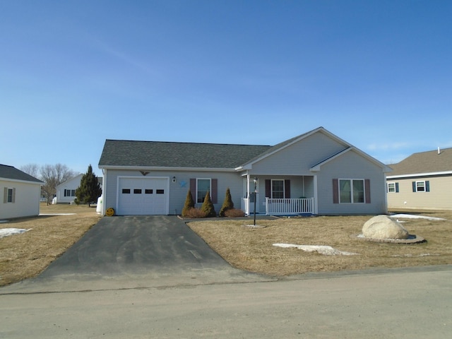 ranch-style home featuring aphalt driveway, an attached garage, covered porch, and roof with shingles