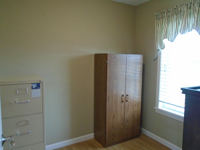 unfurnished bedroom with baseboards and light wood finished floors