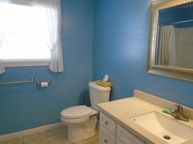 bathroom with vanity, a shower with curtain, baseboards, tile patterned floors, and toilet