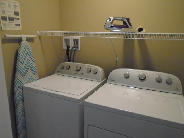 washroom featuring laundry area and washer and clothes dryer