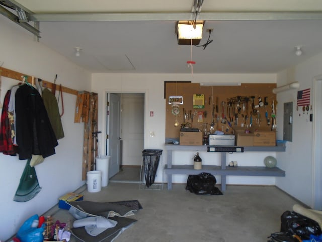 garage featuring electric panel and a garage door opener