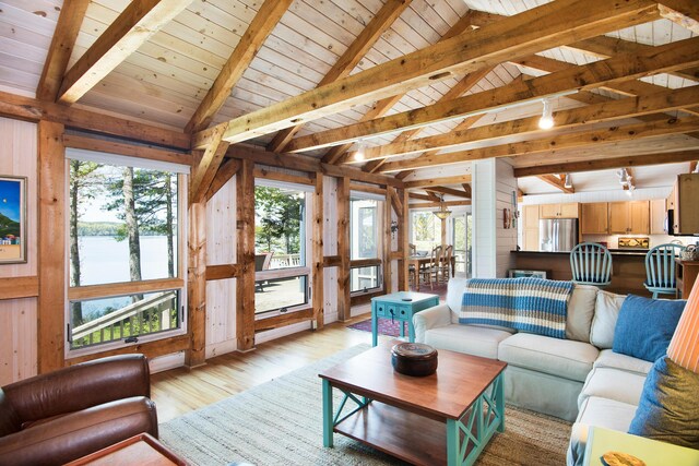 29 Good Day Dr, South Bristol, ME 04568 - living room with light wood-style flooring, wooden walls, wood ceiling, and a water view