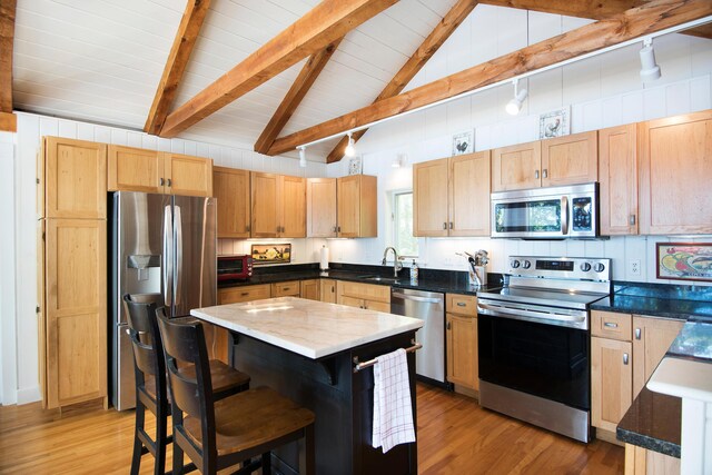 29 Good Day Dr, South Bristol, ME 04568 - kitchen with stainless steel appliances, light wood-style floors, a sink, a kitchen breakfast bar, and a center island