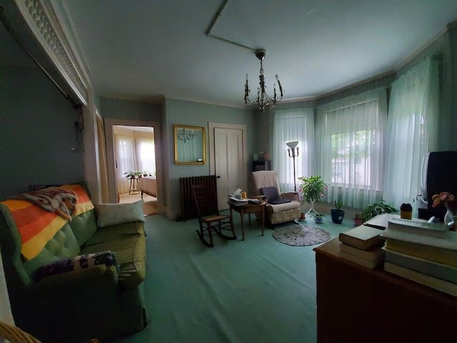 carpeted living room featuring a notable chandelier and a healthy amount of sunlight