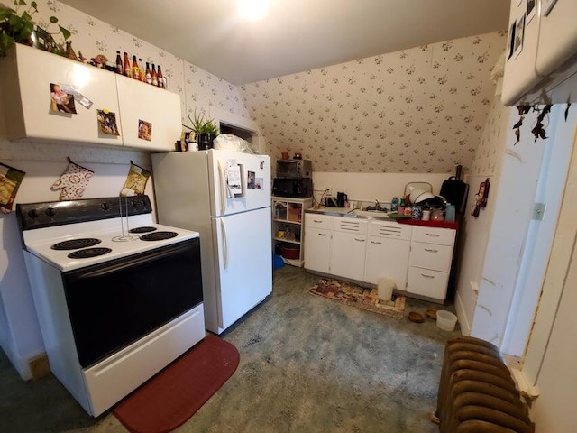 kitchen with white cabinetry, white appliances, wallpapered walls, and a sink