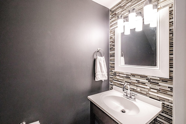 bathroom featuring vanity and backsplash