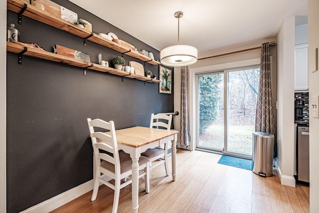 dining room featuring baseboards and light wood finished floors